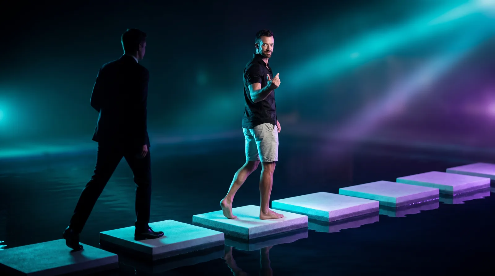 Matt Clark leading a prospect across five glowing stepping stones over dark water